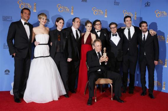 The cast and crew of "American Hustle" pose backstage with their Best Picture - Comedy or Musical award at the 71st annual Golden Globe Awards in Beverly Hills